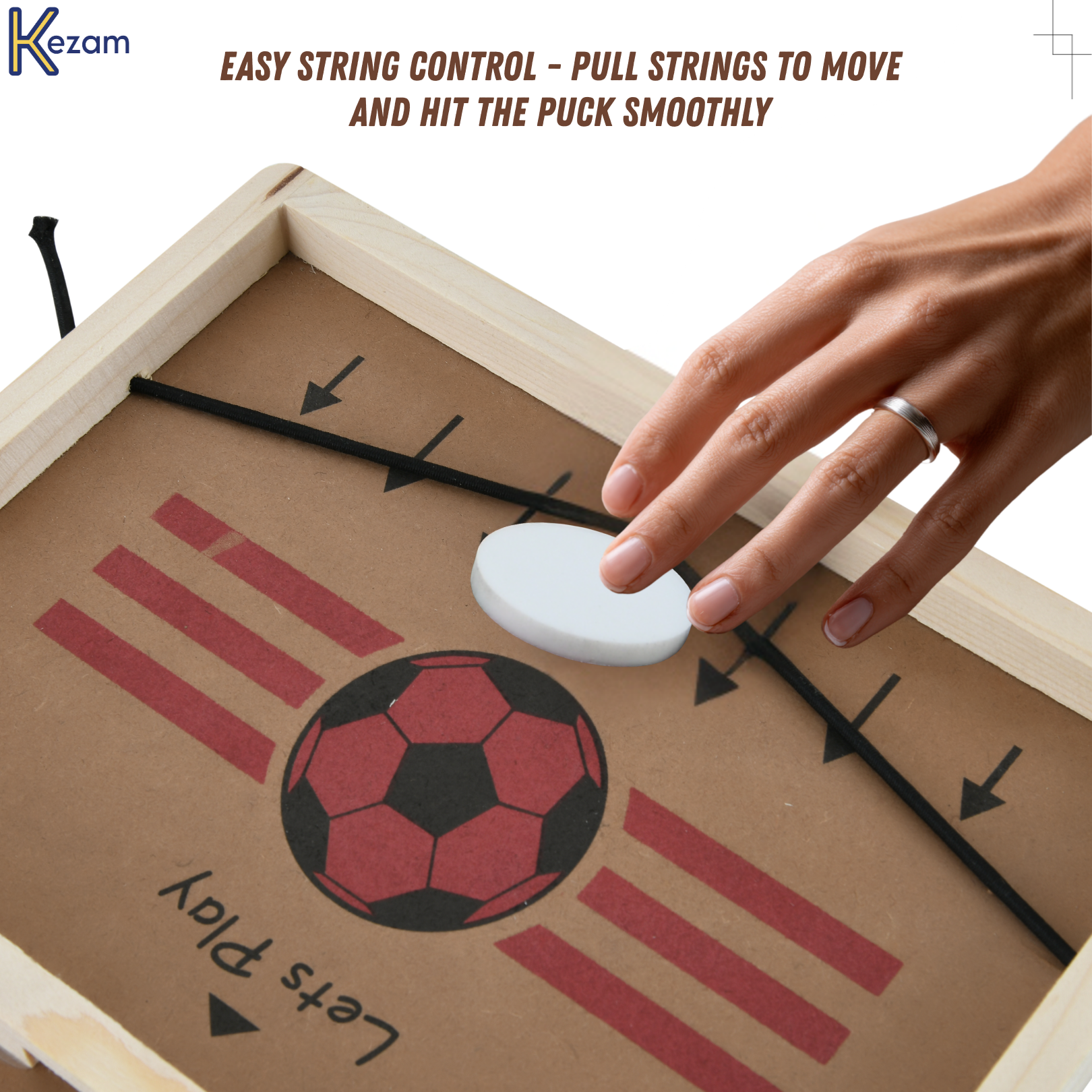 Hand controlling elastic strings on hockey game board showing how strings guide and move pucks for gameplay